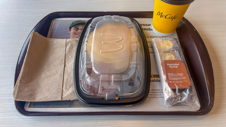 McDonald's pancake container, syrup, and coffee on a tray