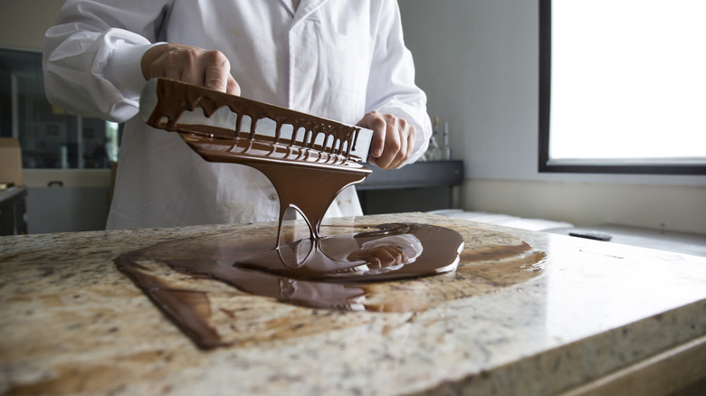 A chocolatier pouring chocolate