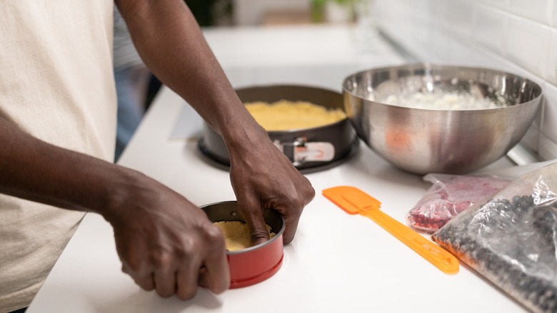Person making springform pan cheesecake