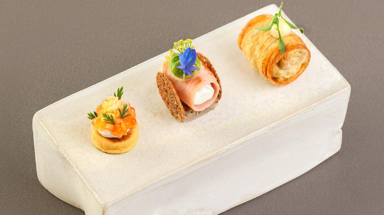 Three amuse-bouche on white block
