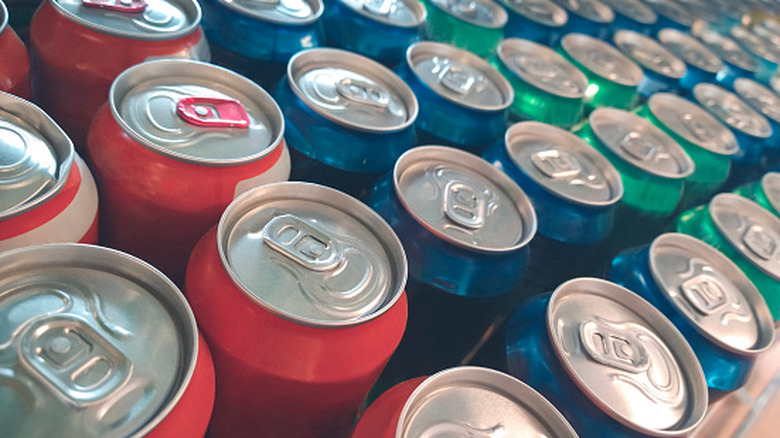 A view of the top of a range of soft drink cans