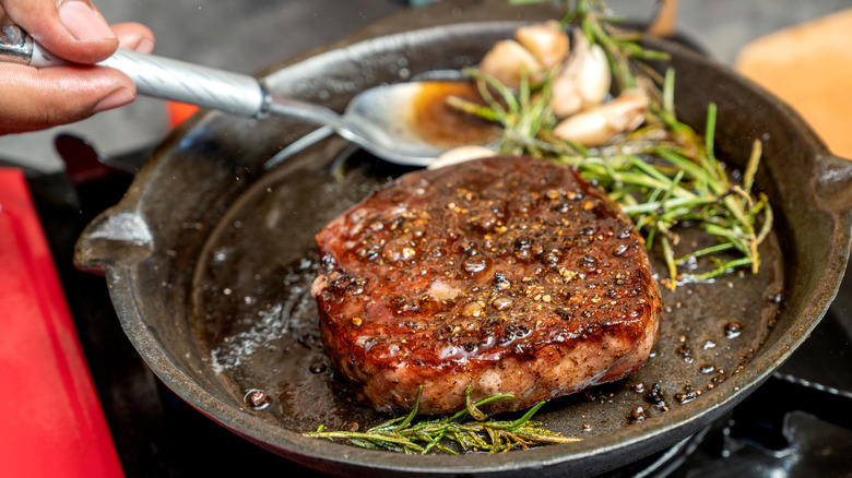 Steak cooking in a pan