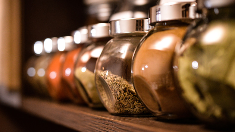Spice jars lined up on a shelf