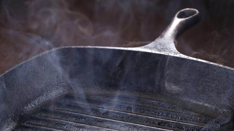 smoking grill pan with oil in it
