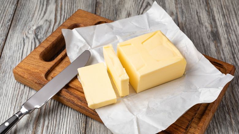 stick of butter cut into slices on wrapper