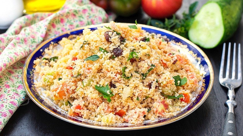 White, blue, and gold plate filled with Moroccan couscous salad