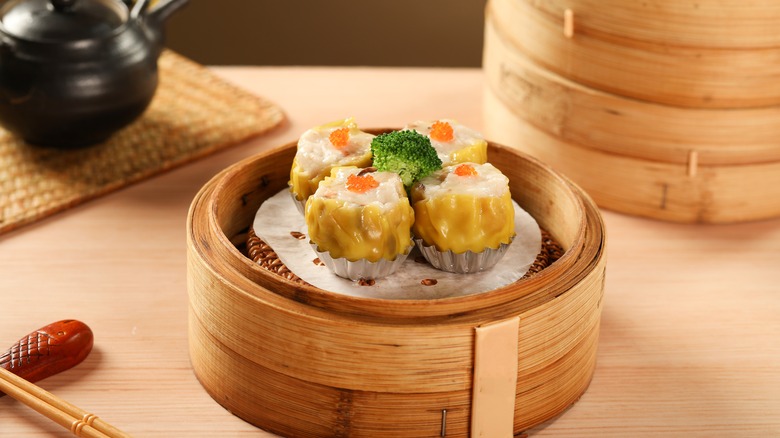 Siu mai dumplings in a bamboo steamer.