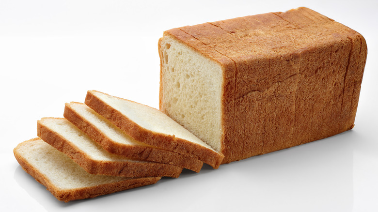 Sliced loaf of white bread on white background