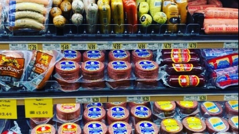Grocery store shelves stocked with different brands and kinds of Lebanon bologna