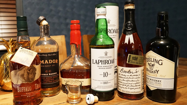 Various bourbon bottles sitting side by side on a table