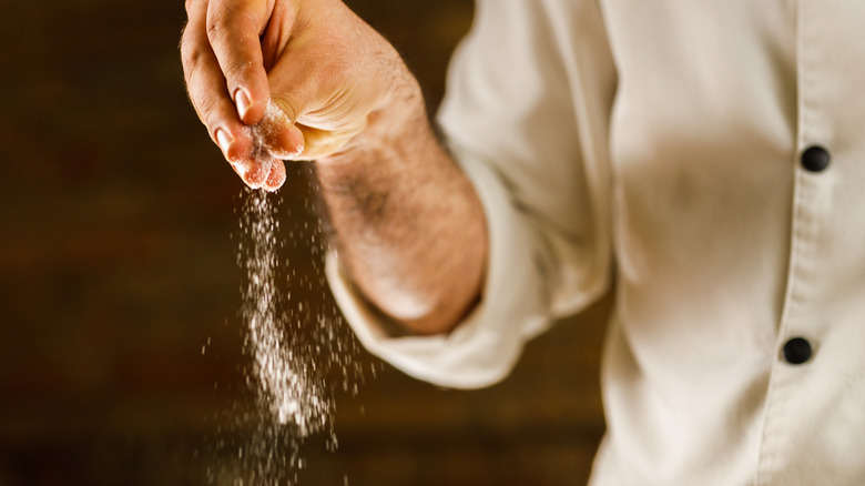 Male chef seasoning food
