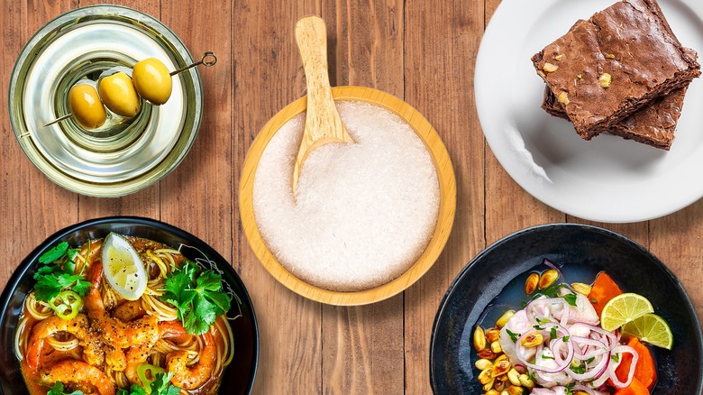 Bowl of MSG surrounded by various dishes and drinks it's used in