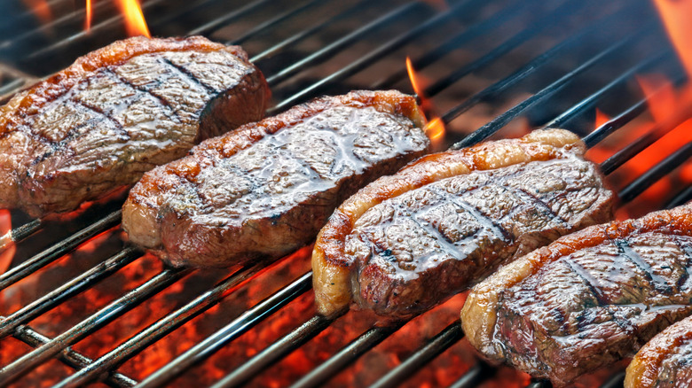 Picanha steaks cooking on a grill