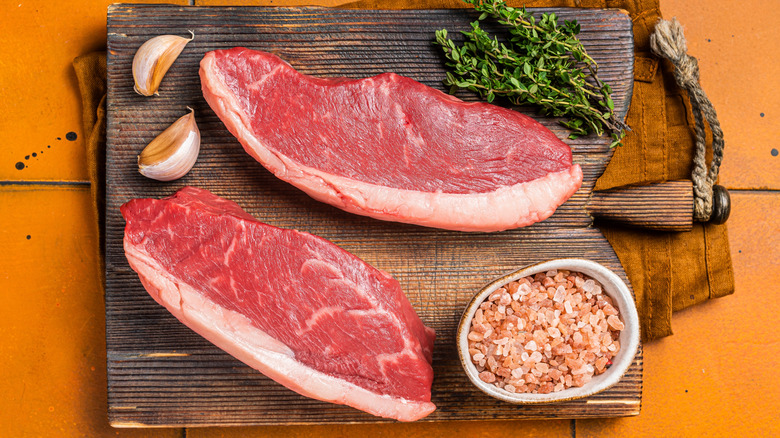 Two raw picanha steaks on a cutting board