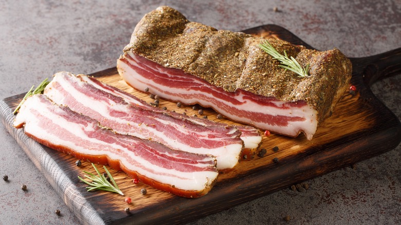 Slab of pancetta with slices in front