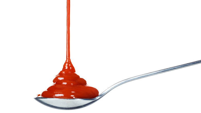 Ketchup being squirted onto a spoon