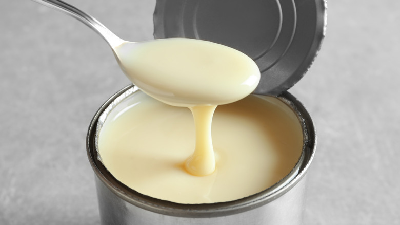 Spoon in a can of evaporated or condensed milk