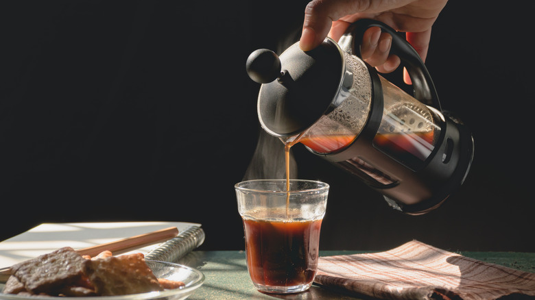 French press coffee being poured into cup