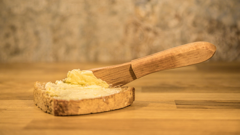 knife resting on buttered piece of toast