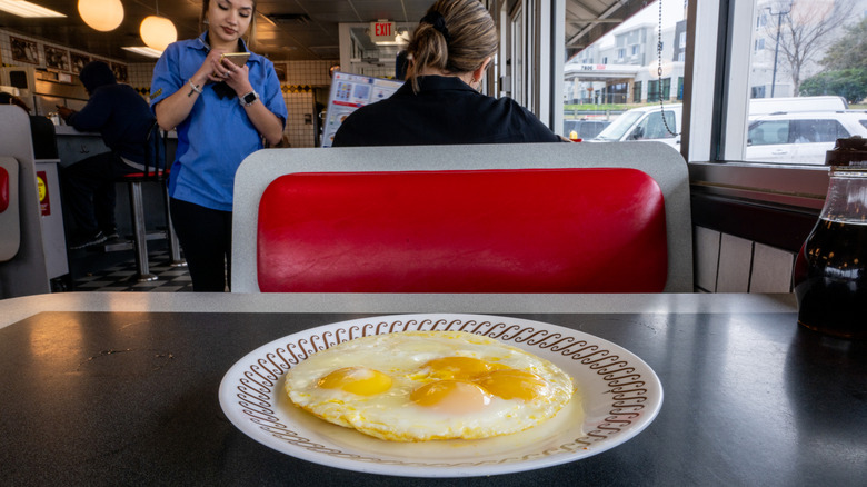 A plate of eggs on a diner table