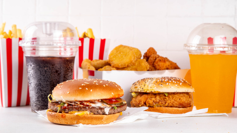 Fast food burger, chicken sandwich, french fries, nuggets, and soft drinks