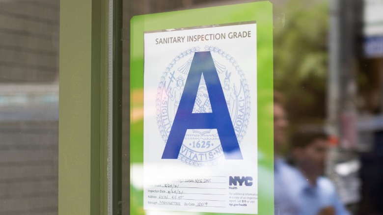 An A-grade score from a health inspection posted in an NYC restaurant window.