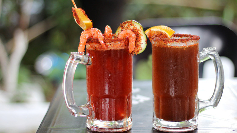 Two micheladas with garnishes