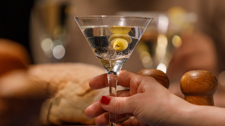 Hand holding martini glass
