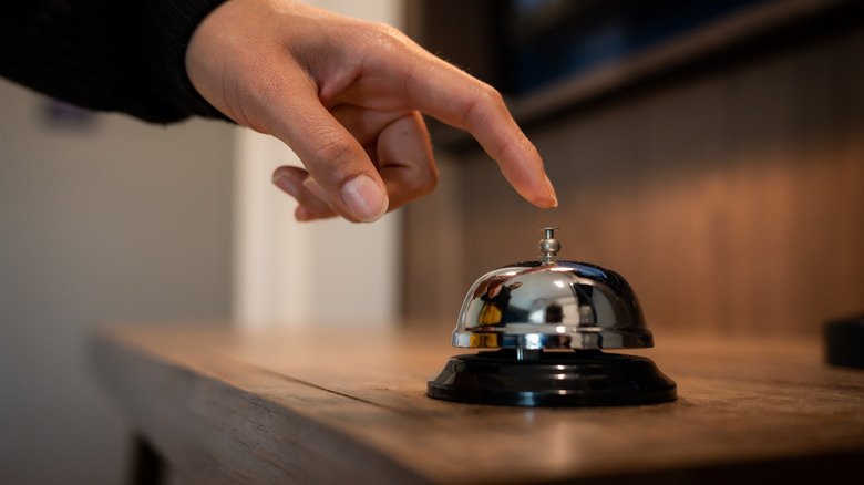 Person about to ring a bell