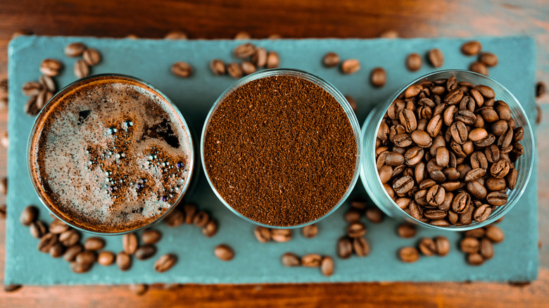 three cups of geisha coffee, whole beans, ground beans, and coffee
