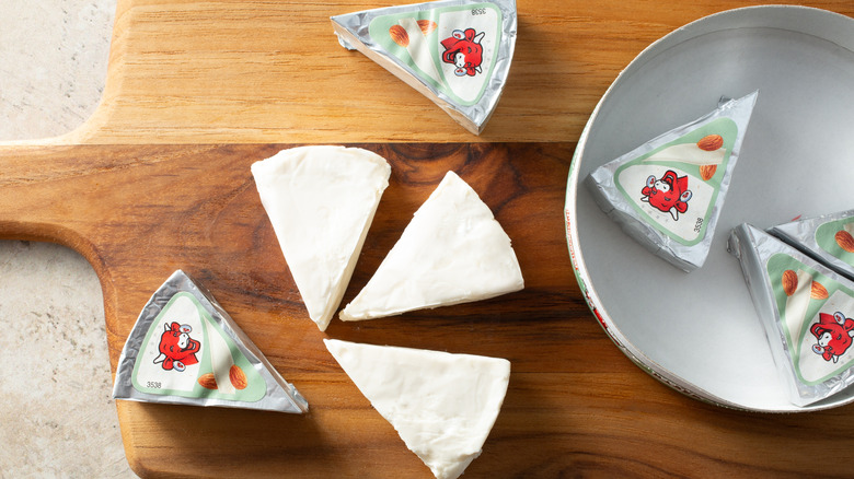 laughing cow cheese wedges on a cutting board