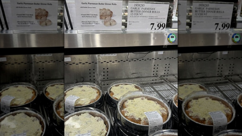 A refrigerated display at Costco containing packages of the garlic Parmesan butter dinner rolls