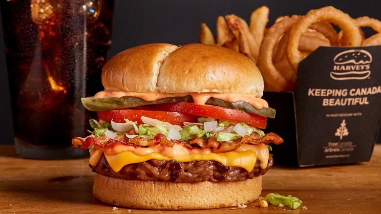 Burger, fries, onion rings, and a drink from Harvey's