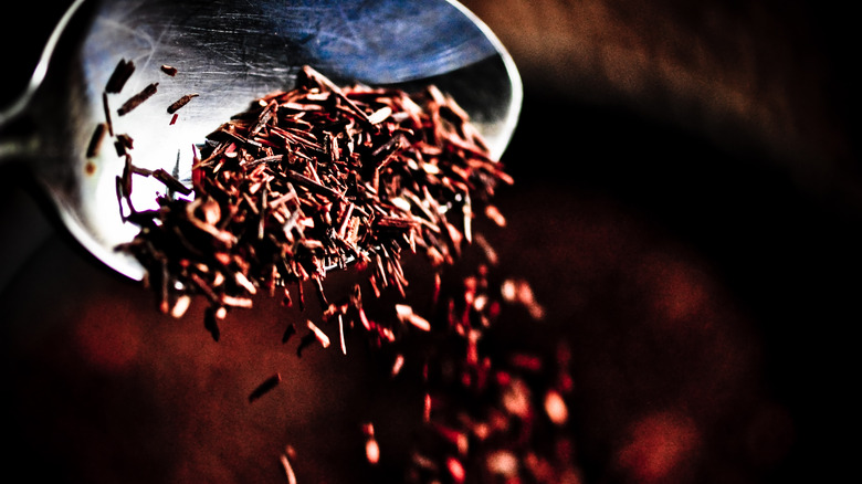 Dry rooibos tea leaves on a spoon