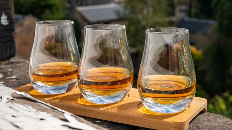 A flight of whiskeys overlooking a hillside