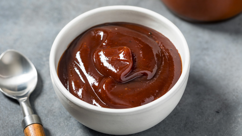 A bowl of BBQ sauce in a white bowl