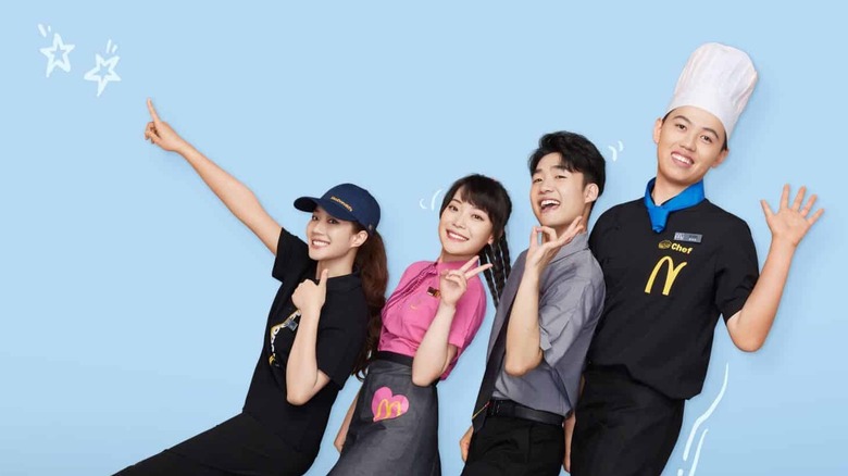 four employees in new chinese uniforms