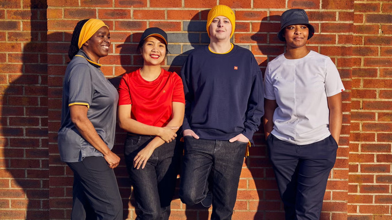 four staff members against wall