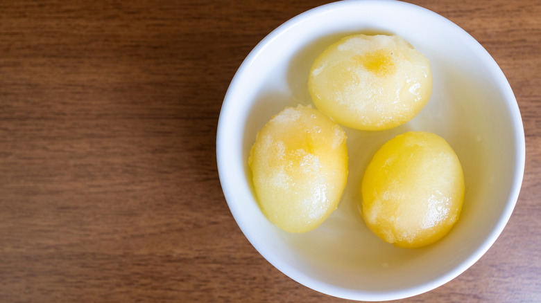 Three peeled raw frozen eggs