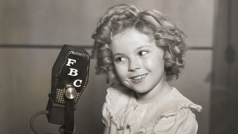 Shirley Temple with a microphone