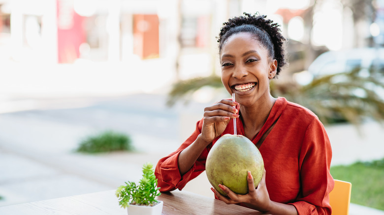 Woman drinks coconut water