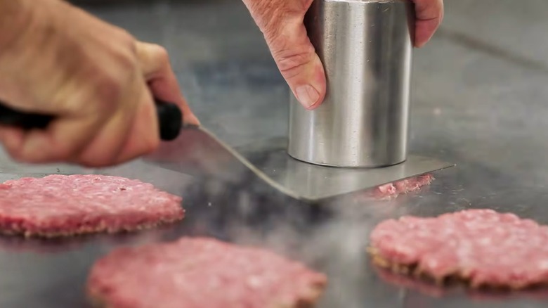 Culver's burger patties cooking on a restaurant grill