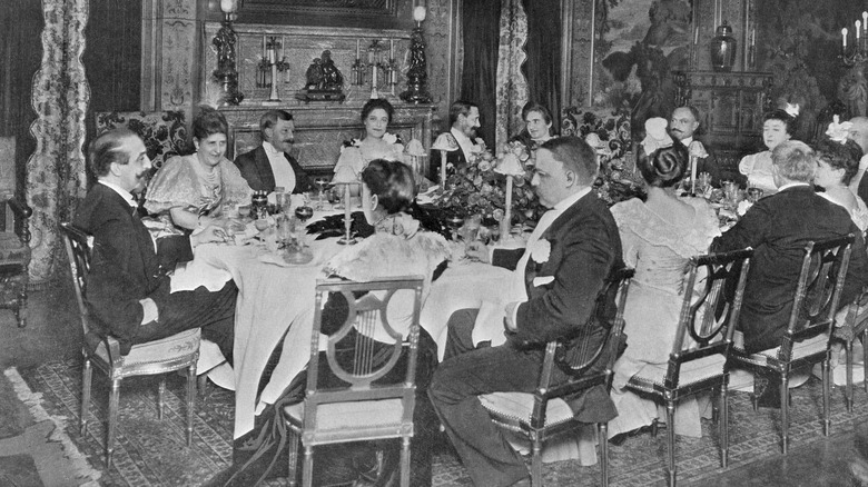 A group of men and women dining at Delmonico's Steakhouse in New York in 1899