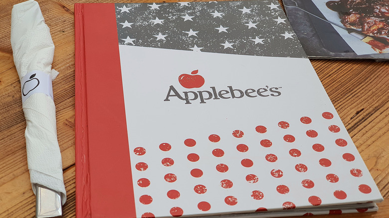 Applebee's menu and cutlery set on a table
