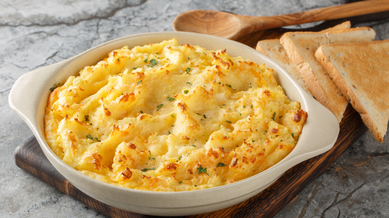 Fluffy mashed potato casserole in a white ceramic dish