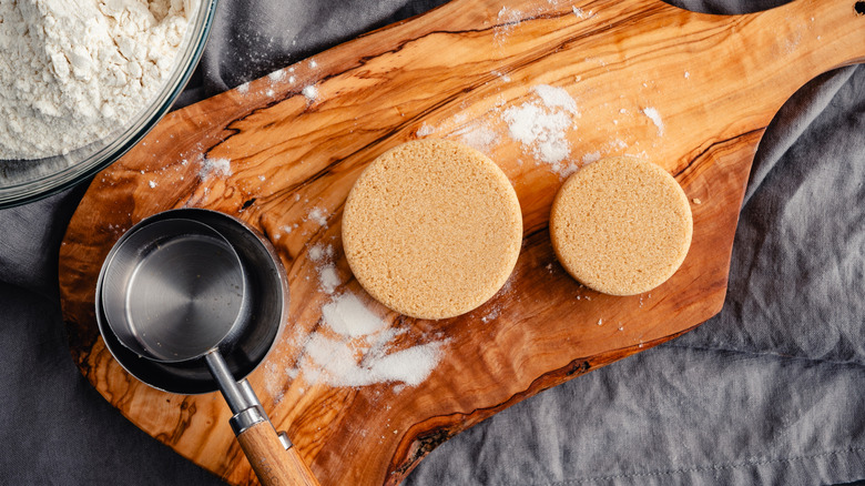 measuring cup and two mounds of brown sugar