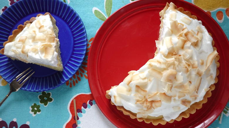 Coconut cream pie with a slice on a plate