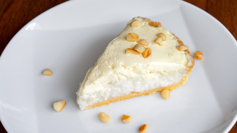 Slice of coconut cream pie with macadamia nuts