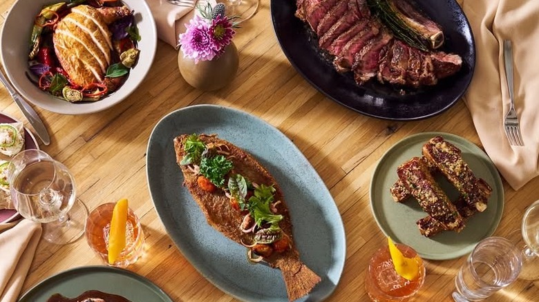 Assorted plates on a wooden table at the Husk