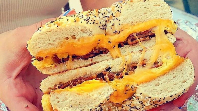 A sammie held in hands at the Queen Street Grocery